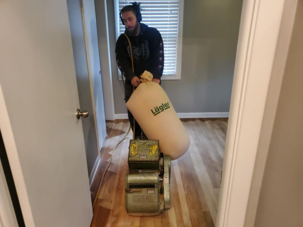 Kenwood Technician sanding hardwood floor